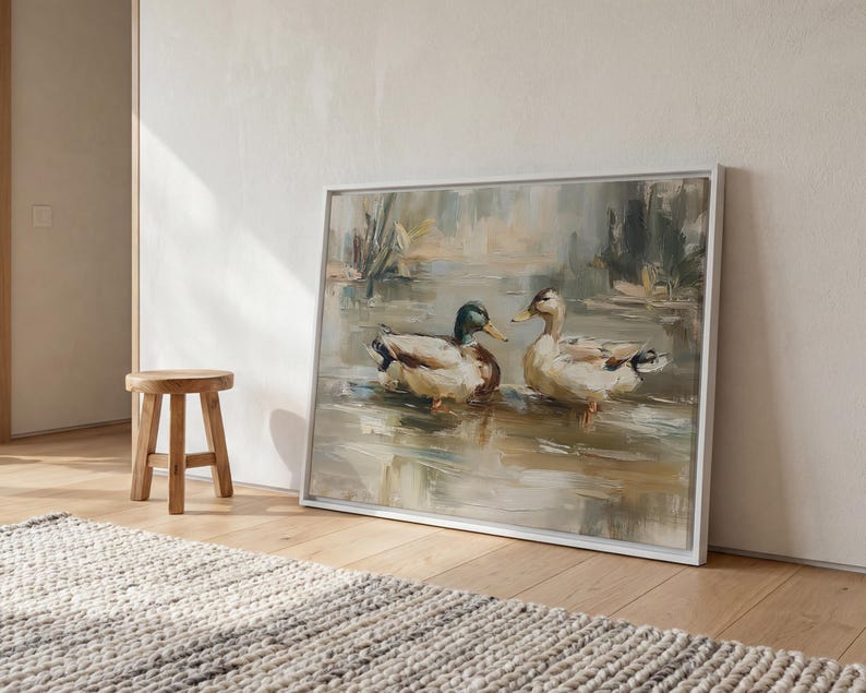 a large painting of two ducks swimming in a pond, displayed on a wall in a room with a wooden stool and a rug.