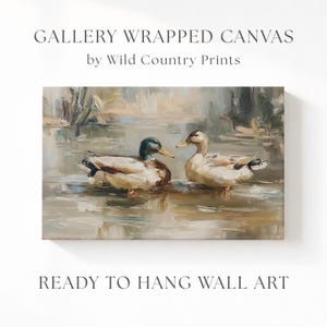 The image is a painting of two ducks swimming in a body of water, with a text overlay that reads "Gallery Wrapped Canvas by Wild Country Prints" and "Ready to Hang Wall Art".