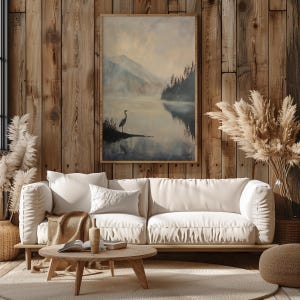 a living room with a white couch and a painting on the wall