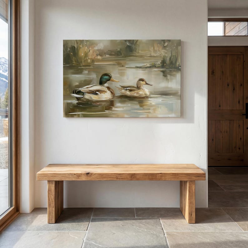 a wooden bench situated in a room with a large painting of ducks on the wall above it.