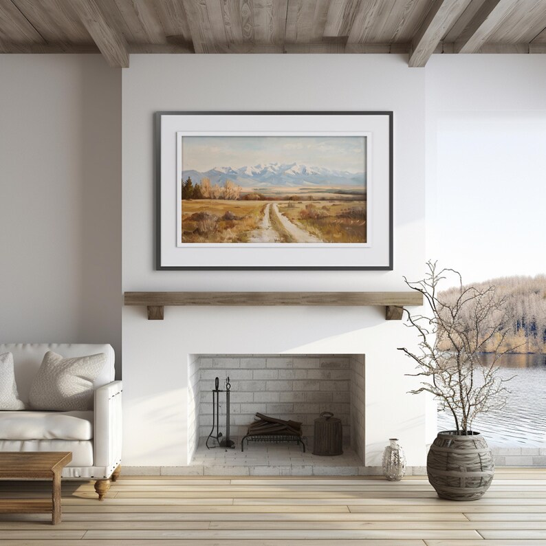 a living room with a fire place and a painting on the wall