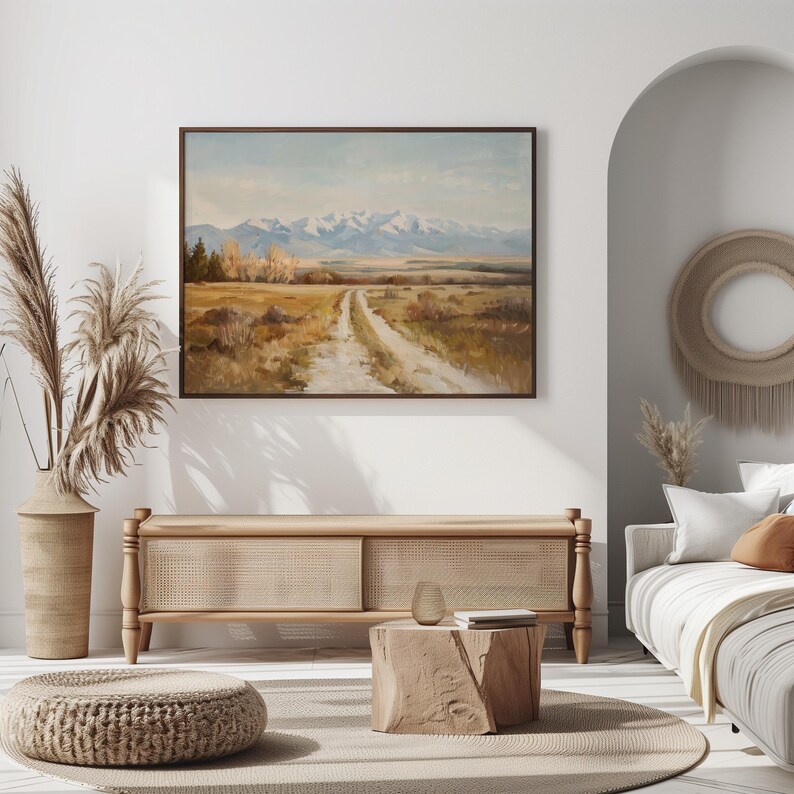 a painting hanging on a wall above a wooden bench