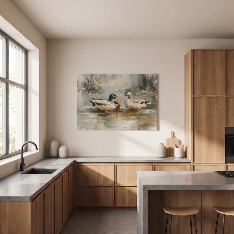 a modern kitchen with wooden cabinets, a large window, and a painting of ducks on the wall.