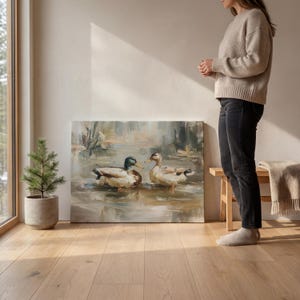 A woman stands in a room with a large painting of ducks on the wall, and a potted plant next to it.