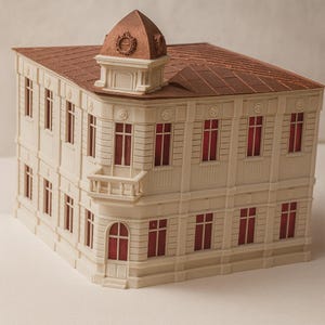 May include: A detailed architectural model of a building with a cream-colored facade and a brown roof. The windows have red accents. A small tower with a decorative element sits atop the corner of the building. The model has a balcony.
