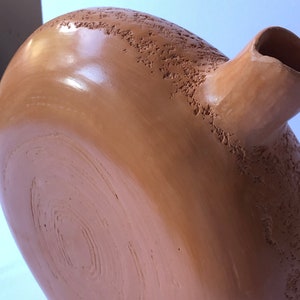 DETAIL of sienna ceramic vase.