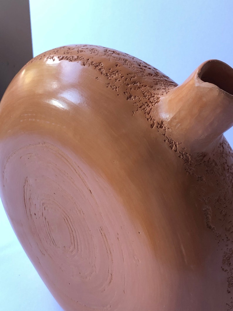 DETAIL of sienna ceramic vase.