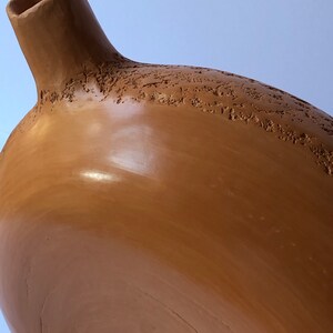 Detail of sienna ceramic vase.