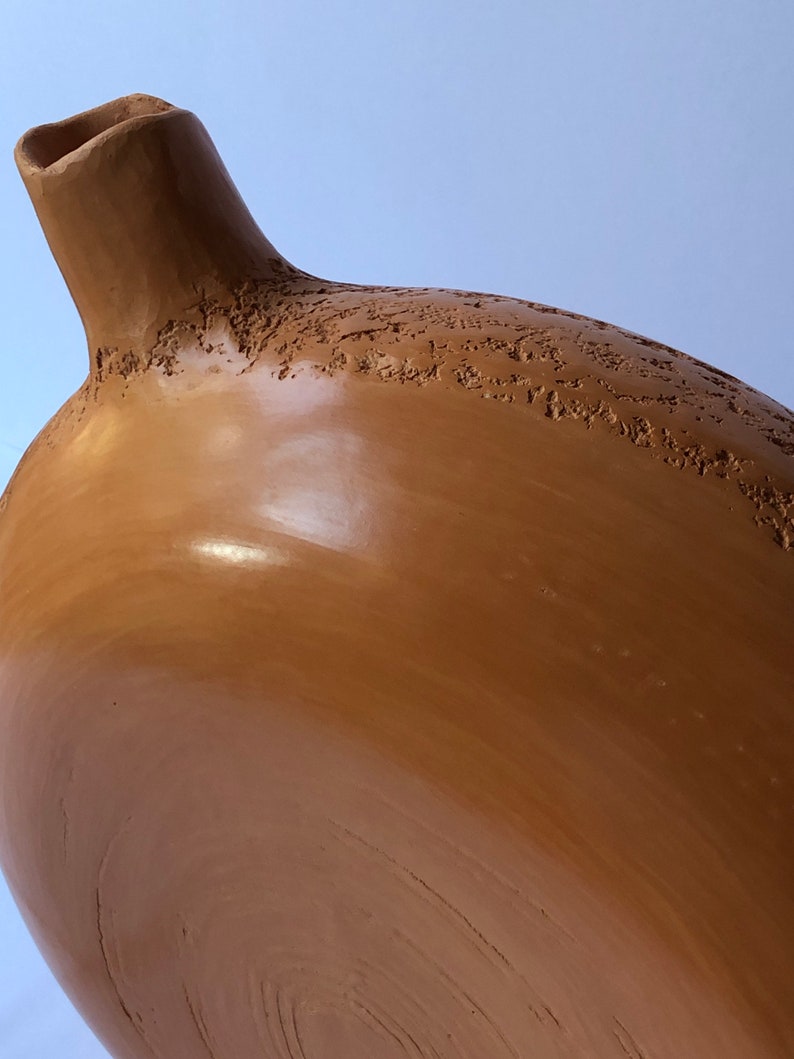 Detail of sienna ceramic vase.