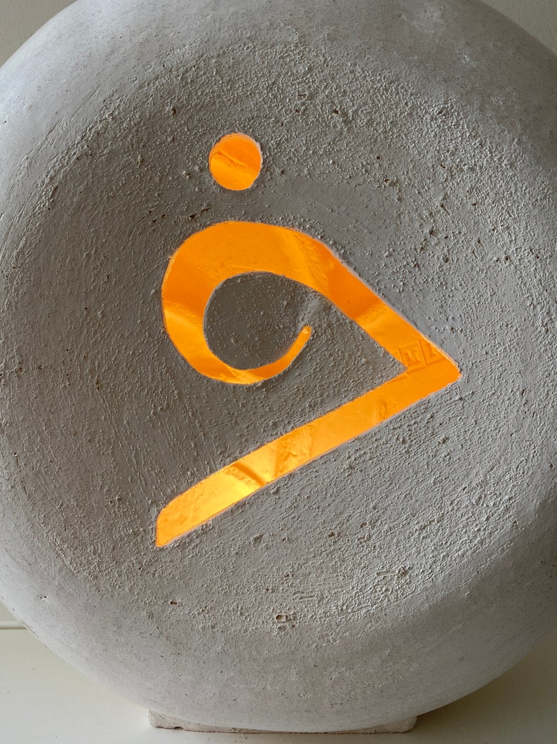 Detail of an off white ceramic ambience lamp.