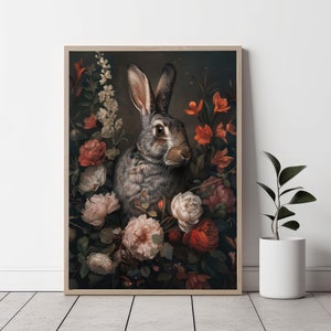 May include: A gray rabbit with brown eyes sits in a bouquet of flowers. The flowers are a mix of red, pink, and white. The rabbit is surrounded by lush green leaves.