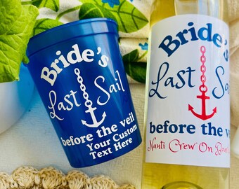 May include: A blue plastic cup and a wine bottle with nautical labels. The cup says "Bride's Last Sail" with an anchor. The bottle label also says "Bride's Last Sail" with an anchor graphic.