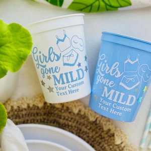 May include: Two plastic cups, one white and one light blue, with the text "Girls gone MILD" and a customisable text area. The cups feature a design of lingerie and stars. Suitable for parties.