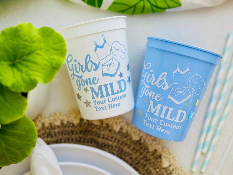 May include: Two plastic cups, one white and one light blue, with the text "Girls gone MILD" and a customisable text area. The cups feature a design of lingerie and stars. Suitable for parties.