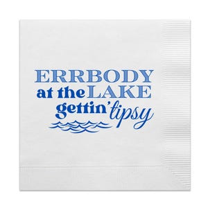 May include: White paper napkin with blue text that reads "ERRBODY at the LAKE gettin' tipsy" with a blue wave design underneath.