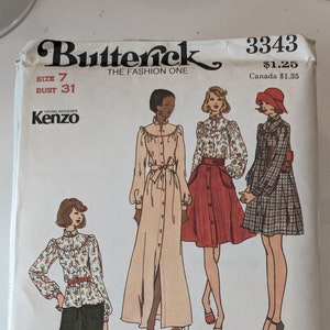 May include: Vintage Butterick sewing pattern 3343 with Kenzo designs. The pattern shows illustrations of outfits, including a long coat, skirt, and trousers. The size is 7, with a bust measurement of 79 cm.