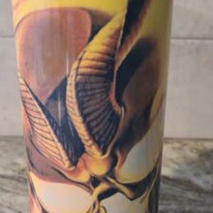 May include: A yellow stainless steel tumbler with a graphic of a skull with horns and flames.