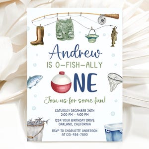 May include: A birthday invitation card featuring watercolor illustrations of fishing gear including a rod, vest, boots, hat, fish, net, and cooler. The text reads: Andrew IS O-FISH-ALLY ONE Join us for some fun! SATURDAY DECEMBER 26TH 2:00 PM - 4:00 PM.