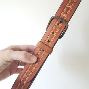 Classic cognac fine leather belt with brass hardware. Bohemian brown leather belt with stitched detailing. 1970&#39;s leather belt. Med. 33&quot;.