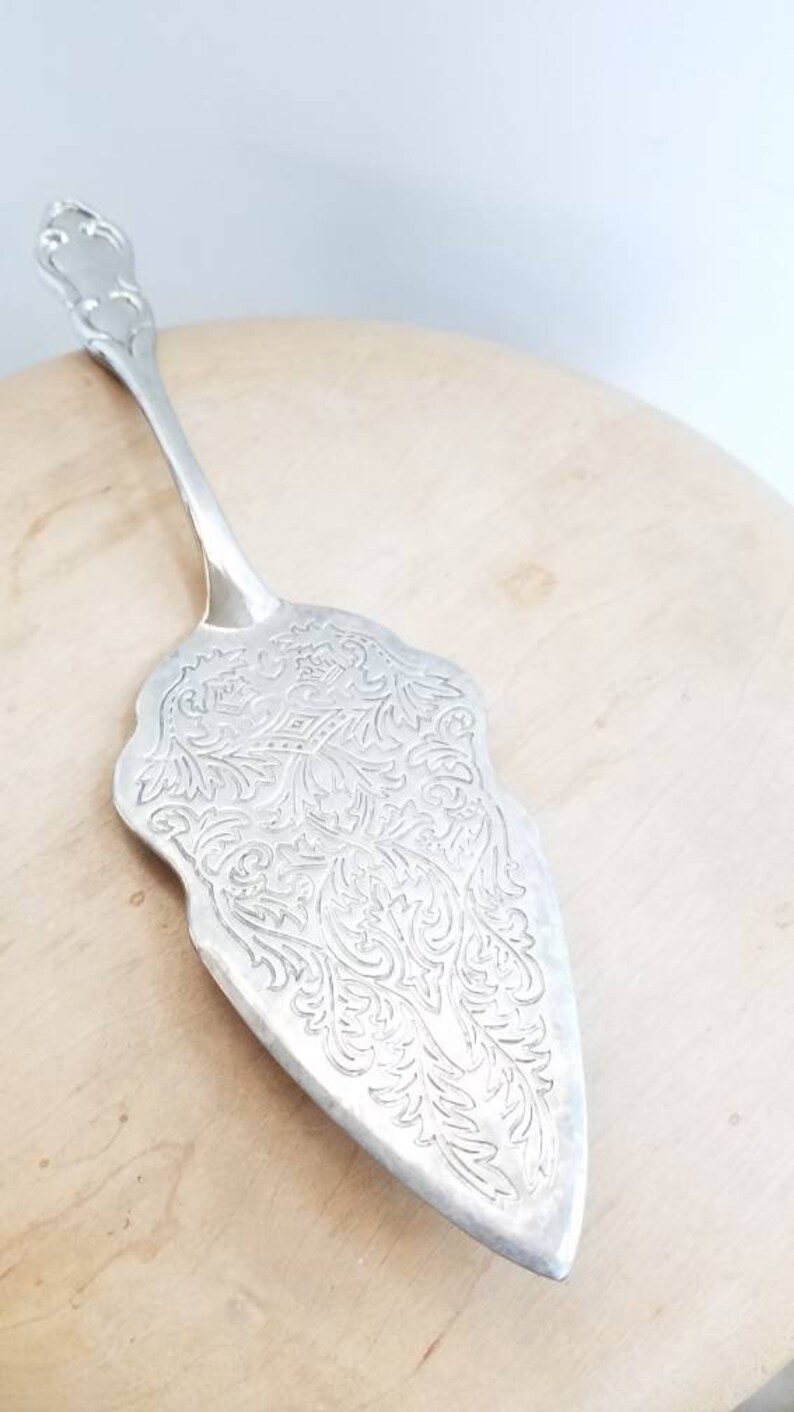 Heavy silverplate pie server with scroll work engraved lift. Vintage silver pie server with engraving