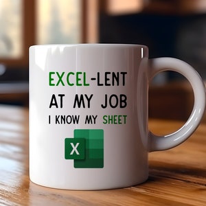 May include: White ceramic mug with a green and black Excel logo and the text "EXCEL-LENT AT MY JOB I KNOW MY SHEET".
