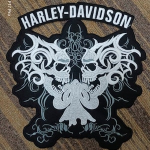 May include: A black embroidered patch featuring a white Harley-Davidson logo and two white skulls with intricate designs.