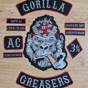 May include: A set of embroidered patches featuring a gorilla wearing a bandana and smoking a cigar, with the text "GORILLA" and "GREASERS". Other patches include "CAP'N AJ", "CHRIS CRASH", "AC", "OLD MAN REYNOLDS", "HEARTACHE DAVE", "LOOSE NUTS WOODY", and "3%".