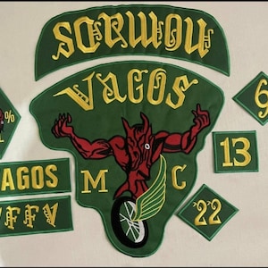 May include: A collection of embroidered patches with green and gold lettering. The patches include the words "SCRWOU" and "VAGOS", along with a devil figure and various numbers. The patches are likely for a motorcycle club.