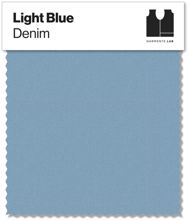 May include: A light blue denim fabric swatch with the text "Light Blue Denim" in black. The swatch has a textured appearance and a jagged edge. The Garments Lab logo is in the upper right corner.