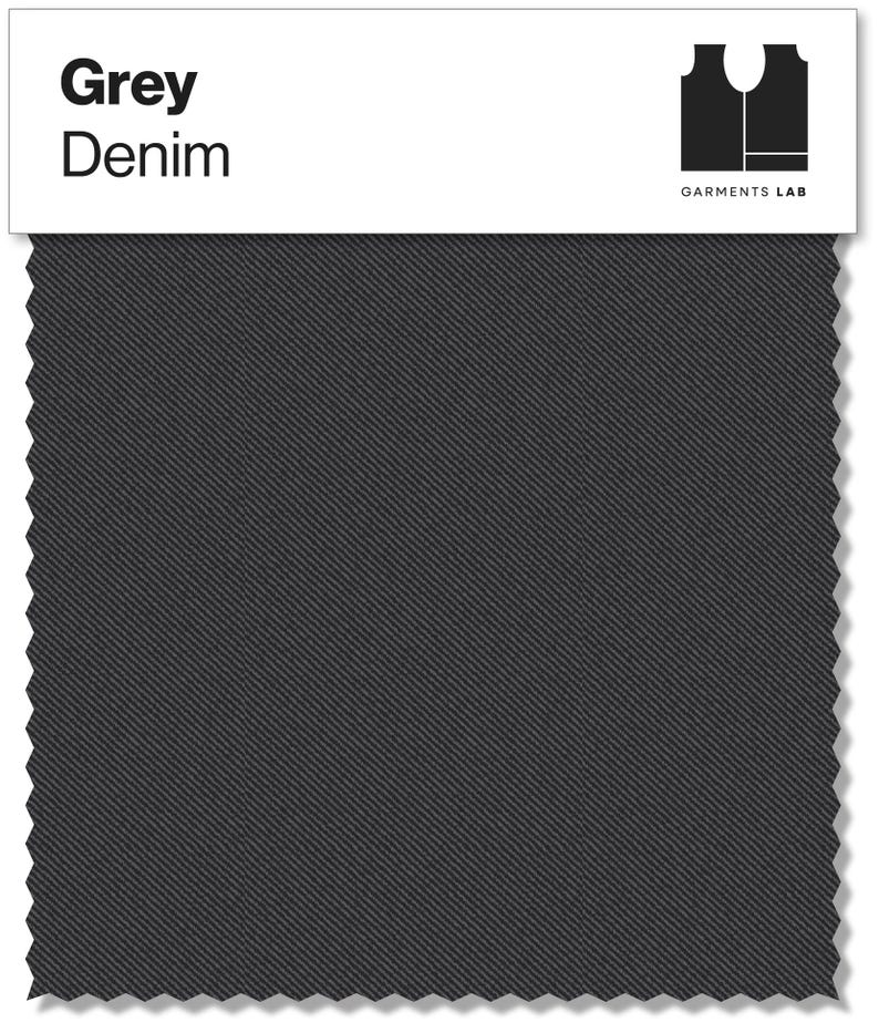 May include: A swatch of grey denim fabric. The fabric has a diagonal weave pattern and is a solid, medium grey color. The words "Grey Denim" are printed in bold, black letters at the top left. The words "GARMENTS LAB" are printed below a black logo at the top right.