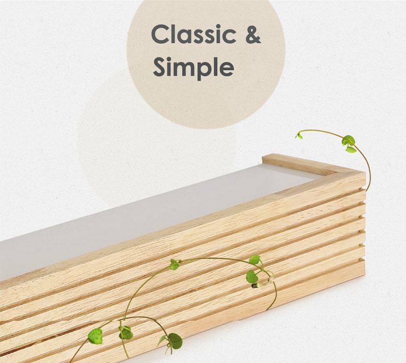 May include: A light wood shelf with a white top and a slatted design. The shelf is empty and has a few green vines hanging from it. The text "Classic & Simple" is written in a circle above the shelf.