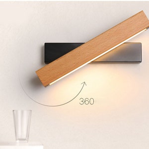 A unique, rotatable wall lamp made from natural wood