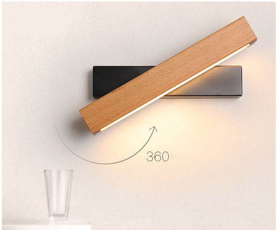 A unique, rotatable wall lamp made from natural wood