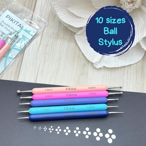 May include: A set of five double-ended ball stylus tools in a gradient of pink, purple, blue, and navy colors. Each tool features the brand name Pikitai and specific metric sizes ranging from 0.5mm to 4.5mm printed on the handles. The set includes 10 sizes.