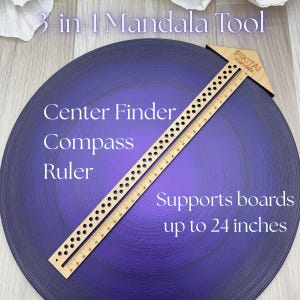 May include: A wooden 3-in-1 mandala tool with the text "Center Finder, Compass, Ruler." The tool includes a ruler with measurements and supports boards up to 24 inches. The tool is on a purple surface.