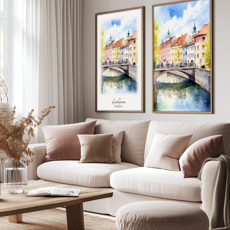 a living room with a couch and two paintings on the wall