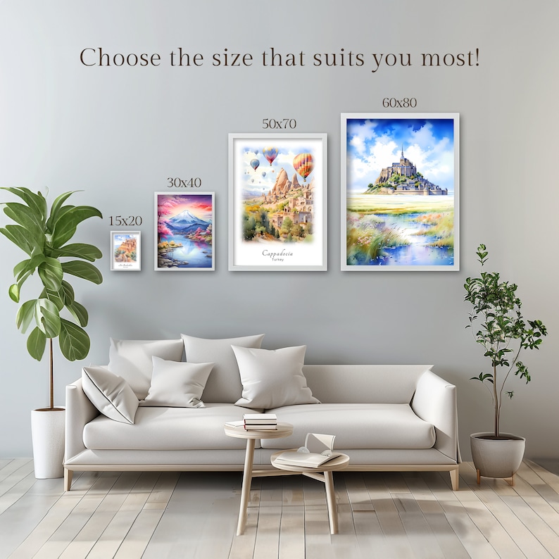 May include: Four framed watercolor paintings of different sizes, showing various landscapes. The paintings are hung on a light gray wall above a white couch. The paintings are labeled with their dimensions: 15x20, 30x40, 50x70, and 60x80.