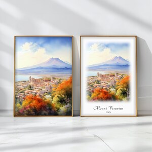 May include: Two framed watercolor paintings of Mount Vesuvius in Italy. The left image shows the mountain in the distance with a town in the foreground. The right image is a close-up of the town with the mountain in the background and the text "Mount Vesuvius, Italy".