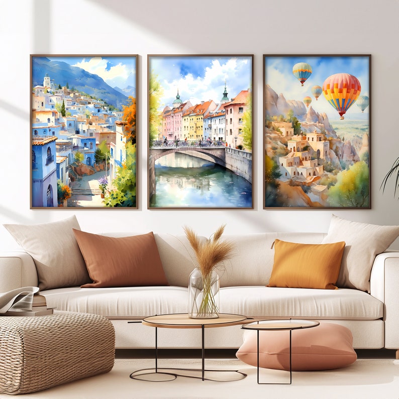 a living room with three paintings on the wall