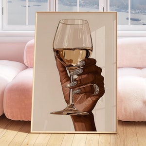 Elevate your space with this stunning ' Black Woman Holding Elegant Wine Glass ' featuring a luxurious hand holding a glass of wine, adorned with sparkling diamond-like nails. Perfect for those who appreciate glamorous home decor, this modern art print adds a touch of sophistication and elegance to any room. Ideal for a chic apartment, living room decor, or as a statement piece in a dining area, this artwork exudes both class and style. Download, print, and enjoy this fashion-forward piece.