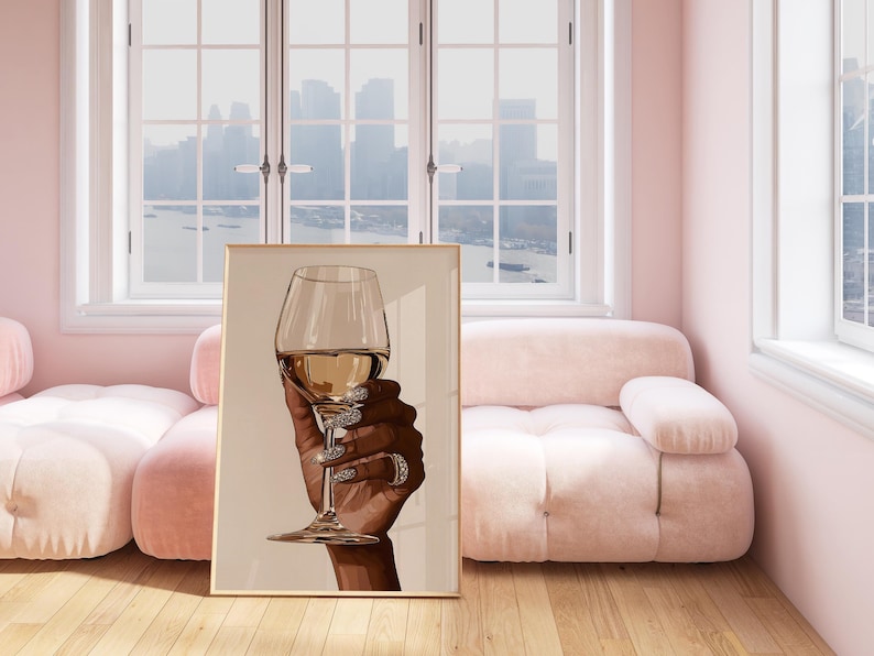 Elevate your space with this stunning ' Black Woman Holding Elegant Wine Glass ' featuring a luxurious hand holding a glass of wine, adorned with sparkling diamond-like nails. Perfect for those who appreciate glamorous home decor, this modern art print adds a touch of sophistication and elegance to any room. Ideal for a chic apartment, living room decor, or as a statement piece in a dining area, this artwork exudes both class and style. Download, print, and enjoy this fashion-forward piece.
