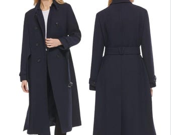 May include: A navy blue double-breasted wool coat with a belt. The coat has a classic trench coat style with a collar, pockets, and a belted waist.