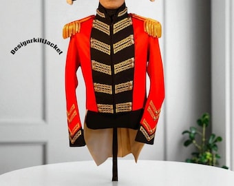 May include: A red military jacket with black accents and gold trim. The jacket features gold epaulets and decorative gold braid. The jacket is displayed on a stand. The text "designrkiltjacket" is visible on the left side of the image.