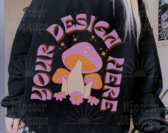 May include: Black sweatshirt with a pink and orange mushroom graphic and the text "Your Design Here" in a retro font.