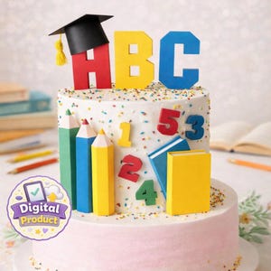 May include: A two-tiered cake decorated with school-themed elements. The top layer has a graduation cap, ABC letters, and numbers. Colorful pencils and books adorn the sides. The cake is covered in white frosting with sprinkles and a pink base.