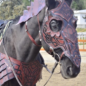 May include: A black horse wearing a brown leather armor with intricate designs. The horse is wearing a helmet with a geometric pattern and a noseband.