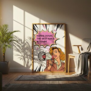 Artistic shot of a nail salon marketing poster leaning against a wall with plant shadows. "Hands Down The Best Nails In Town" quote in comic font. Retro-modern fusion decor for a stylish nail tech station.