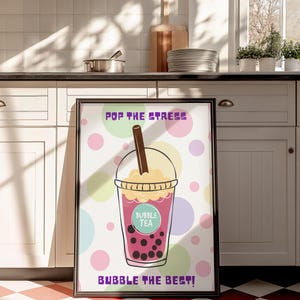 Könnte beinhalten: Ein gerahmtes Poster mit weißem Hintergrund und bunten Punkten. Das Poster zeigt eine Comic-Illustration eines Bubble-Tea-Bechers mit dem Text "Pop the stress, Bubble the best!" und "Bubble Tea" auf dem Becher.