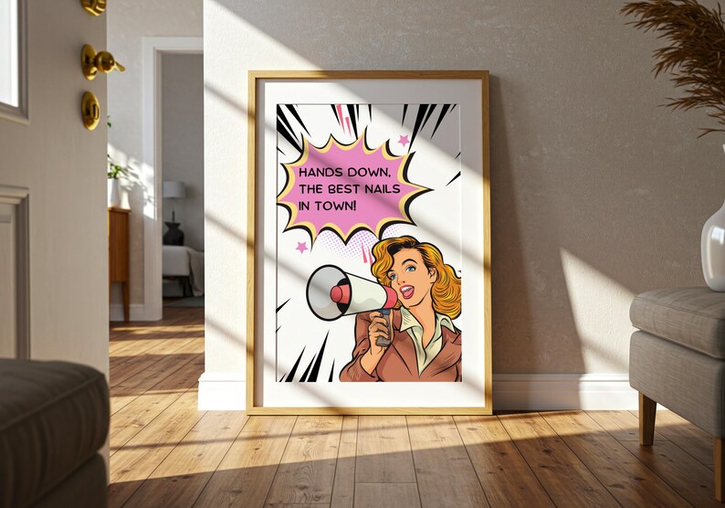 Bright hallway decor with a framed pop art poster leaning on the floor. Natural sunlight highlights the vibrant pink and yellow colors. Welcoming entrance sign for a trendy nail studio or spa to showcase confidence.