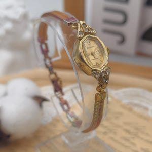 Vintage 1960s Lucerne Ladies Mechanical Watch Gold Tone Case Rhinestone Lugs Rainbow Band
